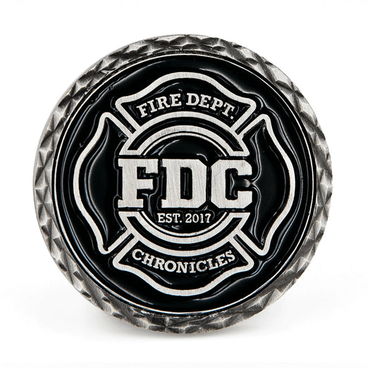 A black coin featuring Fire Department Coffee’s maltese cross logo.