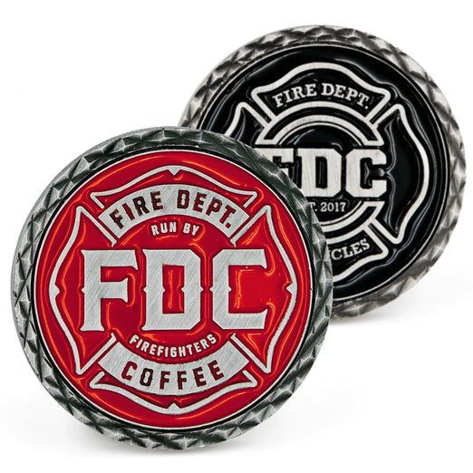2 coins with Fire Department Coffee’s maltese cross logo, one in red and the other in black.