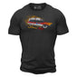 A dark gray t shirt with a ”meat wagon” vehicle on the chest surrounded by flames. Under the vehicle it says ”since 1973”.