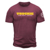 Maroon shirt with "truckie" in bold yellow lettering and "Fire Dept. Coffee" below. FDC maltese cross logo is on the sleeve.