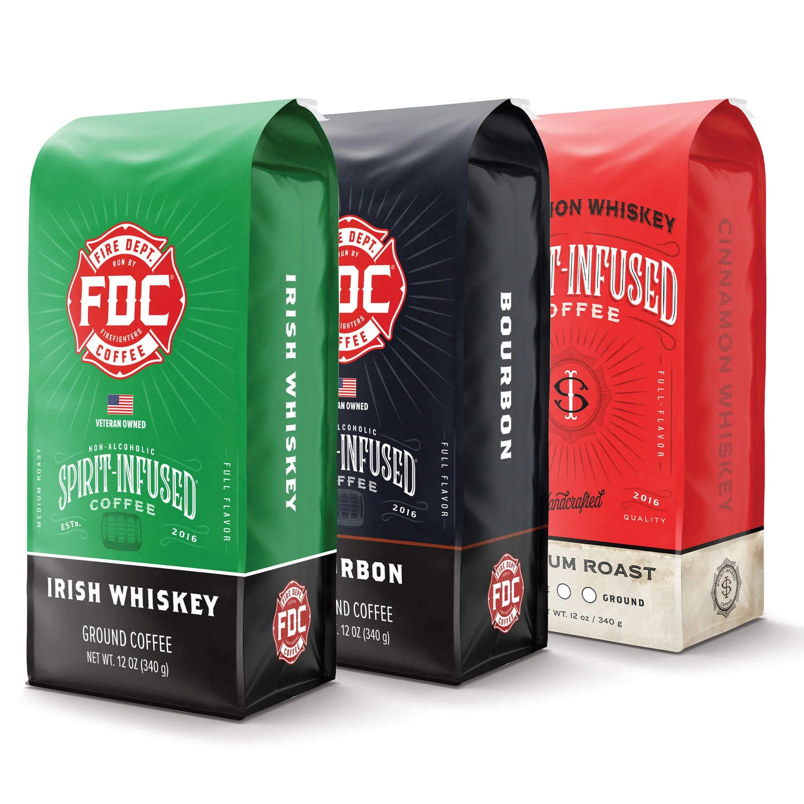 Three bags of Fire Department Coffee's Spirit Infused Coffee. From front to back: Irish Whiskey Infused Coffee bag, Bourbon Infused Coffee bag, and Cinnamon Whiskey Infused Coffee bag.